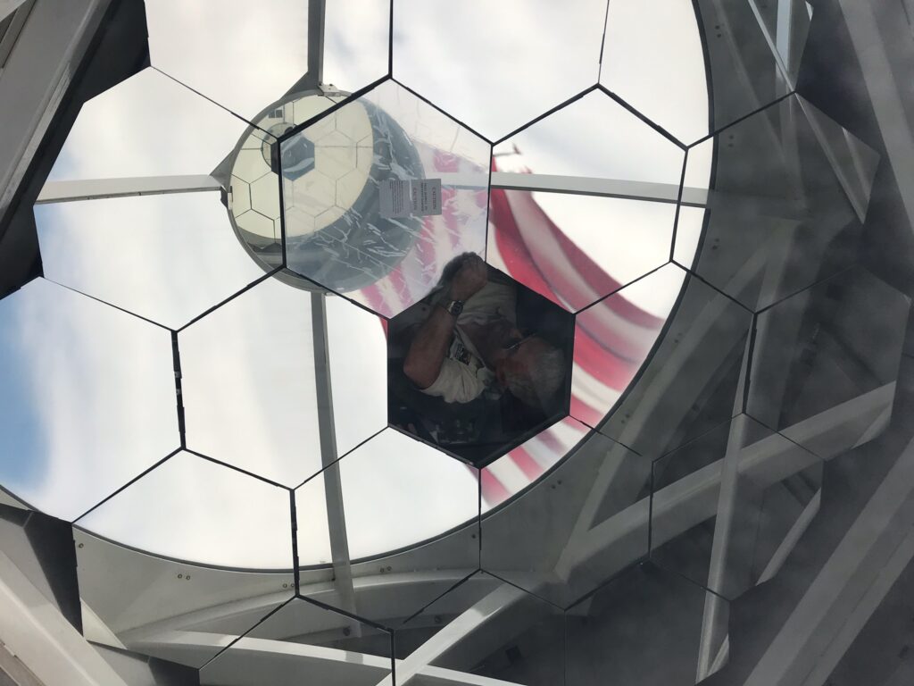 man inside of solar telescope installing mirror