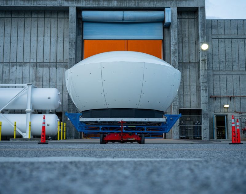 a simulator pod sitting outside a warehouse